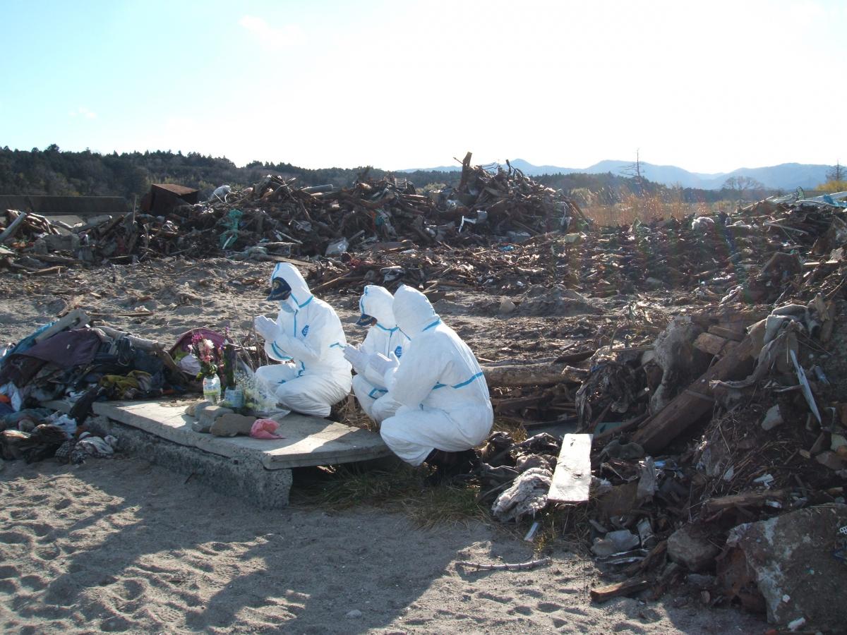 町内の熊川河口付近に訪れ花を手向ける大熊町消防団の代表者（3）