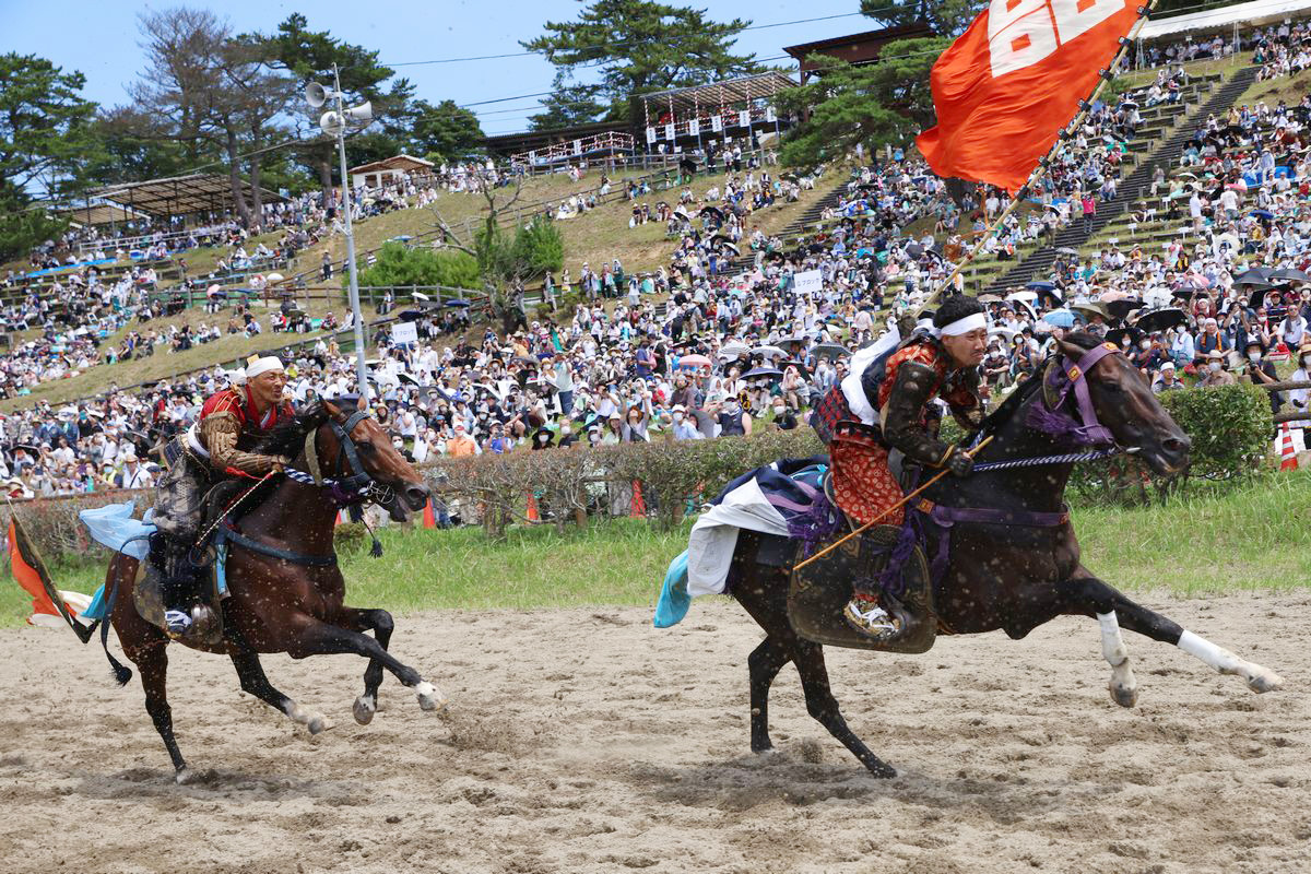 兜をはずし、白鉢巻をしめて1周1000メートルのコースを走る甲冑競馬。町騎馬会から吉田さんが出走（左）しました。