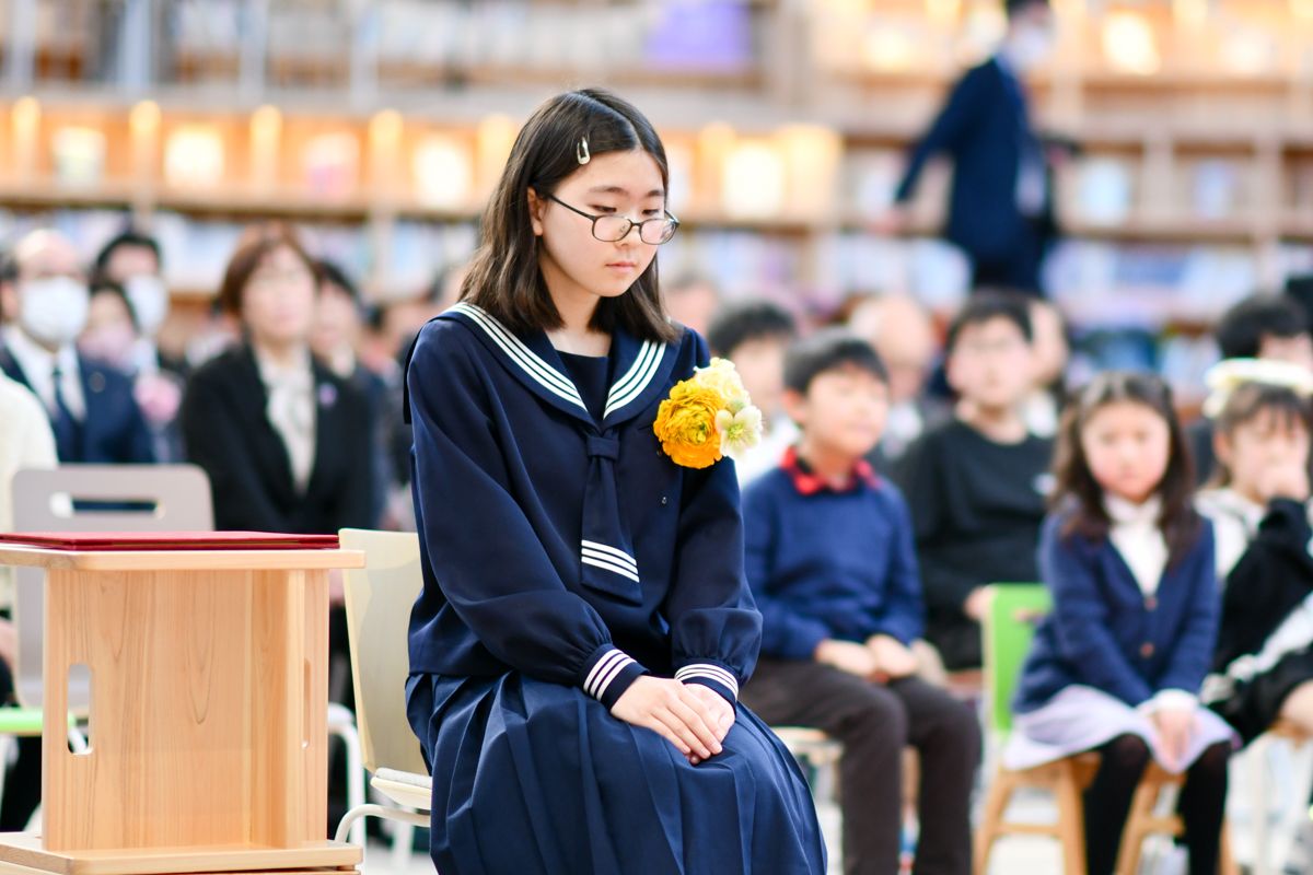 思い出の校舎からの旅立ちに寂しそうな卒業生