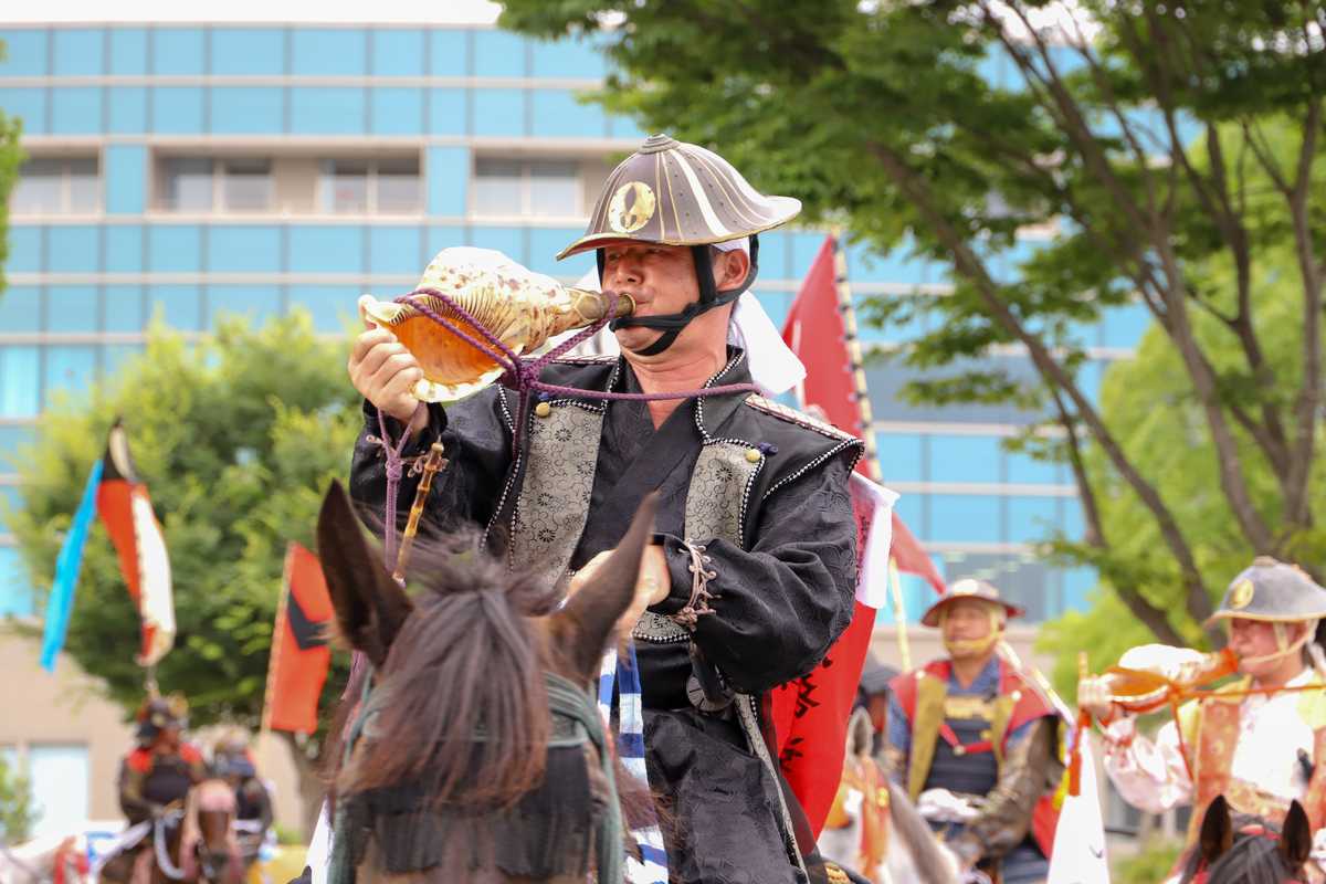 浪江町役場前で陣螺を吹く渡部さん